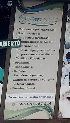 Cartel de Odontoliz con la lista de tratamientos y el WhatsApp